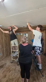 03-screwing-drywall-ceiling-neighbors.webp