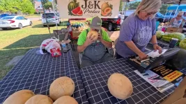 03-farmer-smells-cantaloupe-at-blossom-end.webp